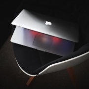 MacBook Pro on black padded chair