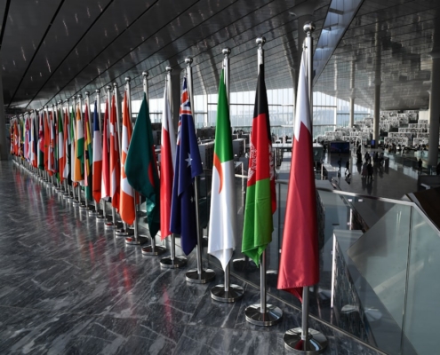 Row of national flags displayed indoors
