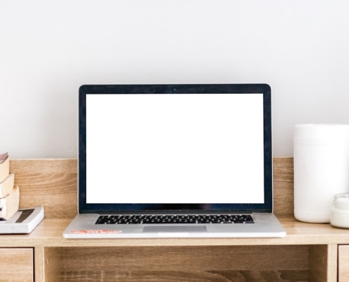 turned-on MacBook on desk