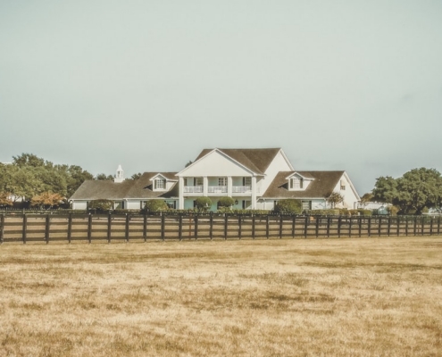 white 2-story house near green trees