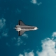 white and black jet plane in mid air under blue sky during daytime