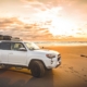 white SUV on beach