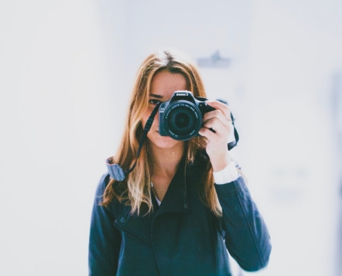 woman taking photo using DSLR camera
