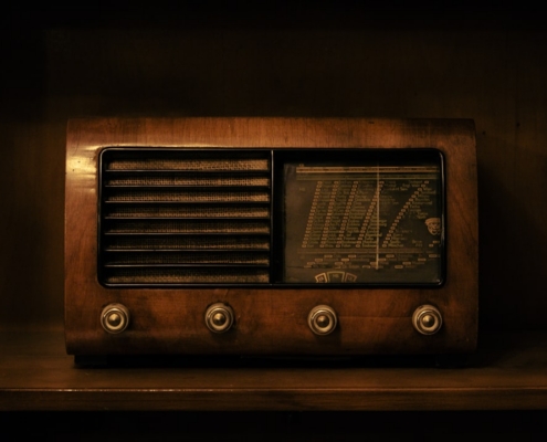 a brown radio sitting on top of a wooden shelf