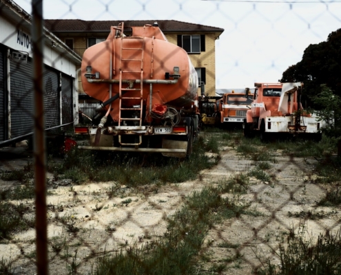 a couple of trucks parked next to a building