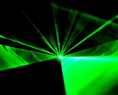 a green light is shining in the dark