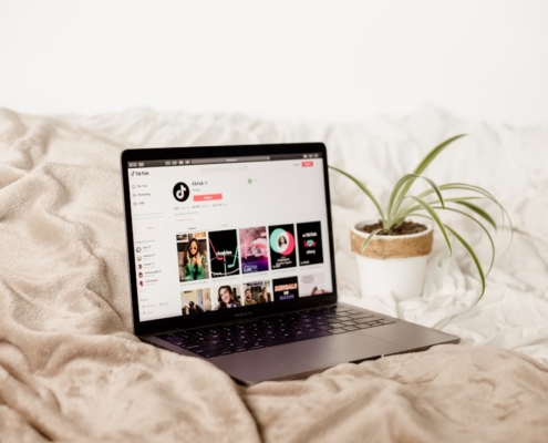 a laptop computer sitting on top of a bed