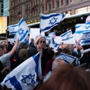 a large group of people holding israeli flags