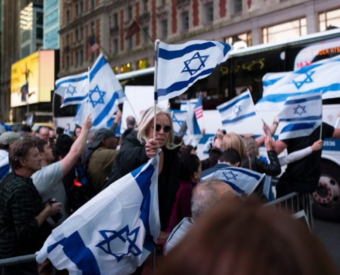 a large group of people holding israeli flags