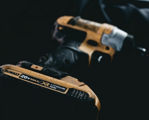 a pair of black and yellow tools sitting on top of a table