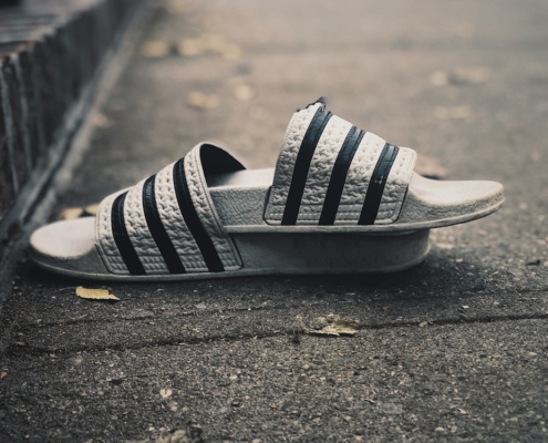 a pair of black and white shoes laying on the ground
