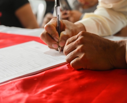 a person writing on a piece of paper