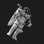 astronaut in white suit in grayscale photography