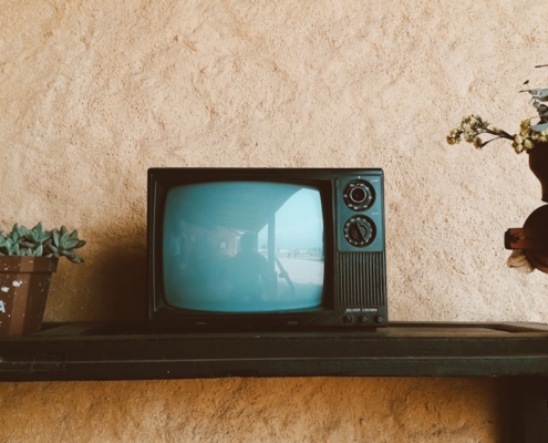 black crt tv on black wooden table