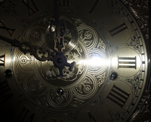 brass-colored analog clock