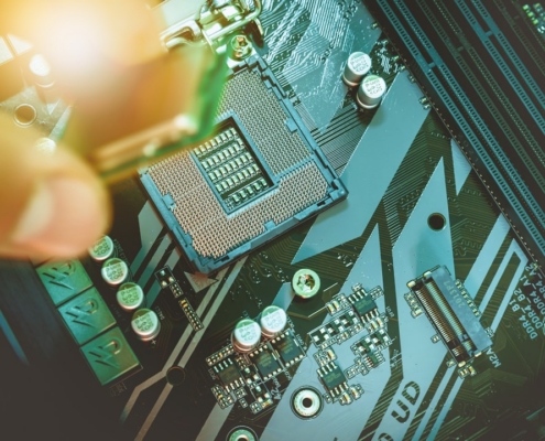Hand installing a computer processor onto a motherboard.