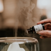 person holding black and white labeled bottle