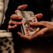 person holding king of spade playing card