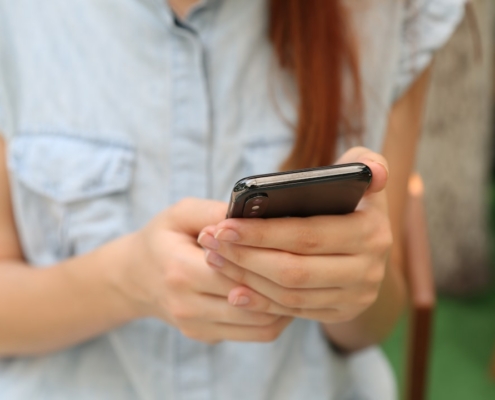 person holding using iPhone X