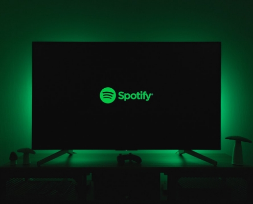 the spotify logo is lit up on a flat screen tv