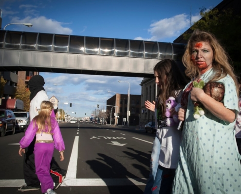 2 women standing on gray concrete road during daytime