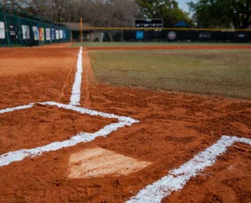 a baseball field with a diamond and a baseball field in the background
