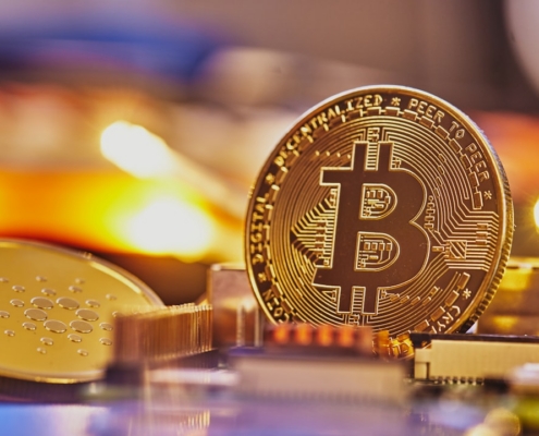 a bit coin sitting on top of a pile of coins