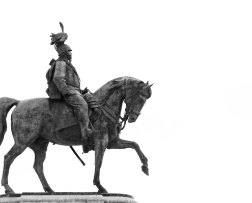 a black and white photo of a statue of a man on a horse