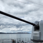 a cannon on a ship near a body of water