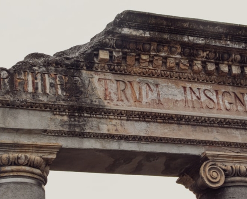 a close up of a stone arch with a sign on it