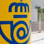 a close up of a blue and yellow sign on a pole