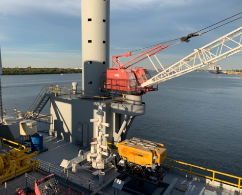 a crane is on the deck of a ship