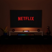 a dark room with a television and a neon netflix sign