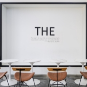 a group of chairs sitting in front of a white wall