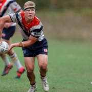 a group of young men playing a game of rugby