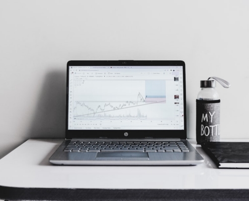 a laptop computer sitting on top of a white desk