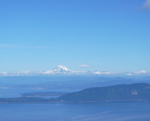 a large body of water with a mountain in the background