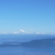 a large body of water with a mountain in the background