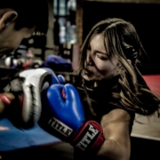 a man and a woman boxing in a gym