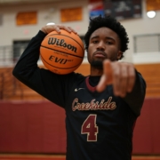 a man holding a basketball in a gym