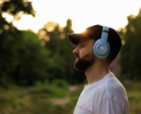 a man wearing headphones standing in a field