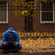 a person sitting on the ground with a tablet