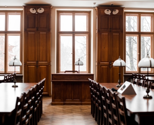 a room filled with lots of wooden tables and chairs