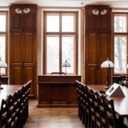 a room filled with lots of wooden tables and chairs