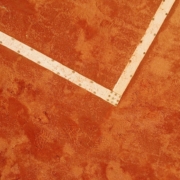 a tennis racket laying on a tennis court