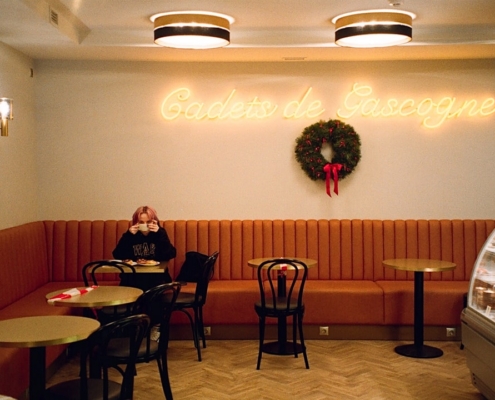 a woman sitting at a table in a restaurant