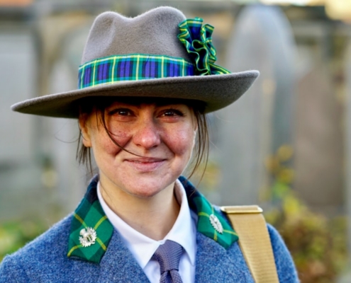 a woman wearing a hat and a blue coat