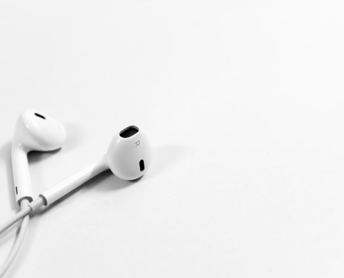 Apple AirPods on white surface