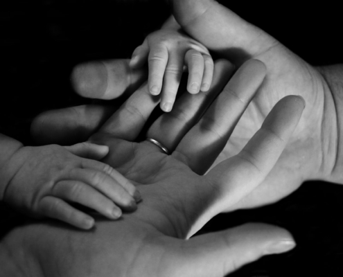 babys hand on human palm