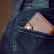 black leather wallet on blue denim jeans